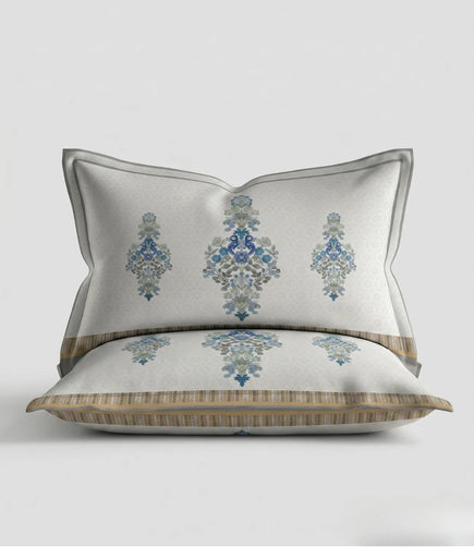 Matching 100% cotton pillow cover featuring a sky blue floral motif with an elegant decorative border on a soft white background.