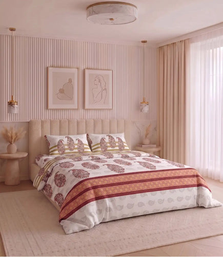 Premium king size 100% cotton bedsheet with a coral pink floral paisley print and matching pillow covers styled in a modern luxury bedroom.