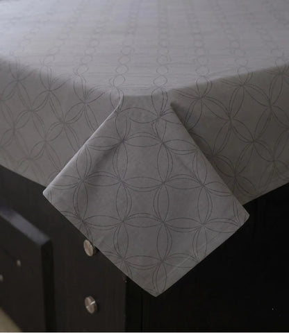 Close-up of a premium 100% pure cotton dark grey geometric bedsheet showcasing its smooth drape, breathable weave, fine stitching, and elegant circular pattern.