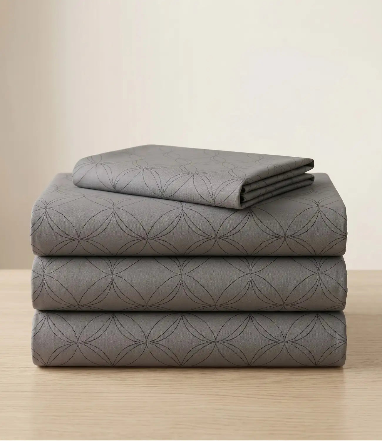Folded king size 100% pure cotton dark grey geometric bedsheet showcasing breathable cotton fabric, subtle circular pattern, premium craftsmanship, durable stitching, and long-lasting comfort.