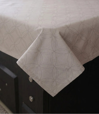Close-up of a premium 100% pure cotton pearl white geometric bedsheet showcasing its smooth drape, breathable weave, fine stitching, and elegant circular pattern.