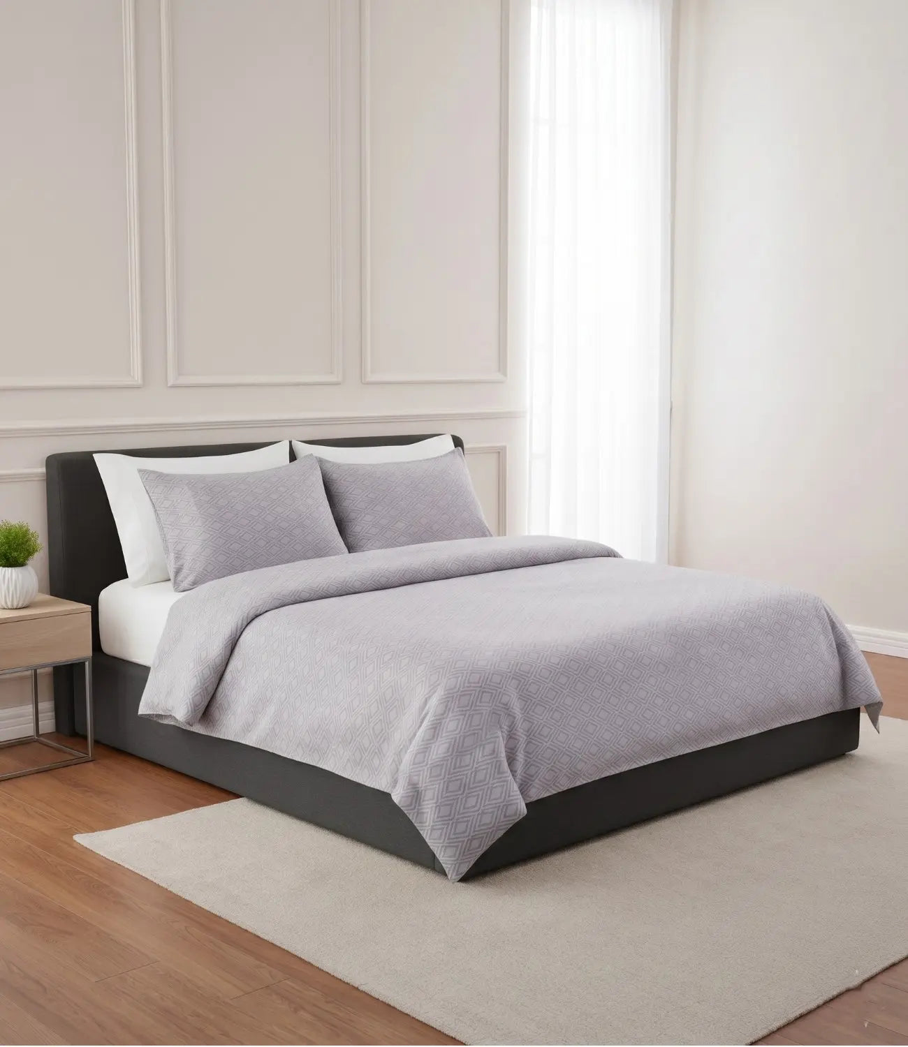 Luxury Mayra silver grey king size cotton bedsheet set with geometric diamond print styled on a modern upholstered bed in a minimalist bedroom.