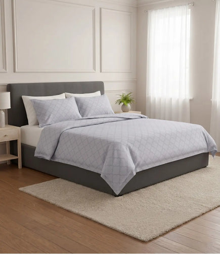 Premium slate blue cotton bedsheet featuring a minimalist geometric print styled on a king size bed in a contemporary bedroom.