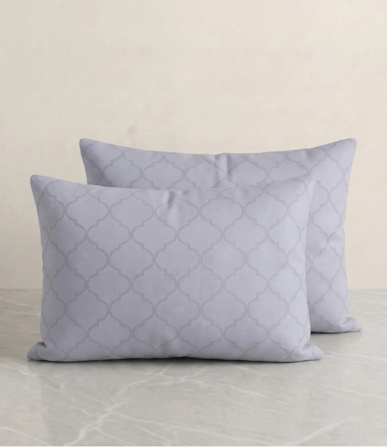 Set of two slate blue cotton pillow covers with a subtle geometric pattern for modern and elegant bedroom décor.