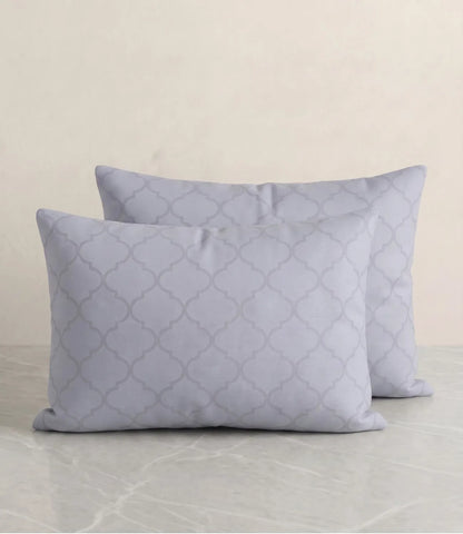 Set of two slate blue cotton pillow covers with a subtle geometric pattern for modern and elegant bedroom décor.