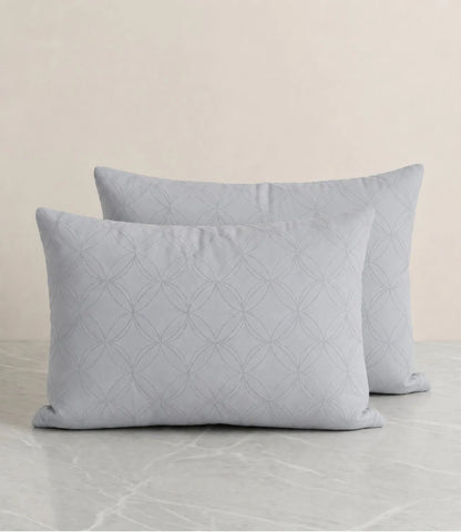 Close-up of a premium 100% pure cotton slate blue geometric bedsheet showcasing its smooth drape, breathable weave, fine stitching, and elegant circular pattern.