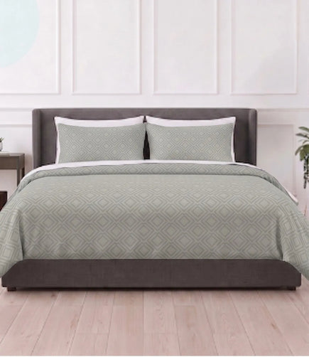 Mayra tea green king size cotton bedsheet with matching pillow covers featuring a modern geometric diamond pattern in a contemporary bedroom.