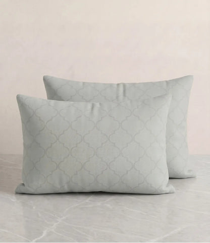 Set of two light sage green cotton pillow covers featuring an elegant geometric quatrefoil pattern and soft breathable fabric.