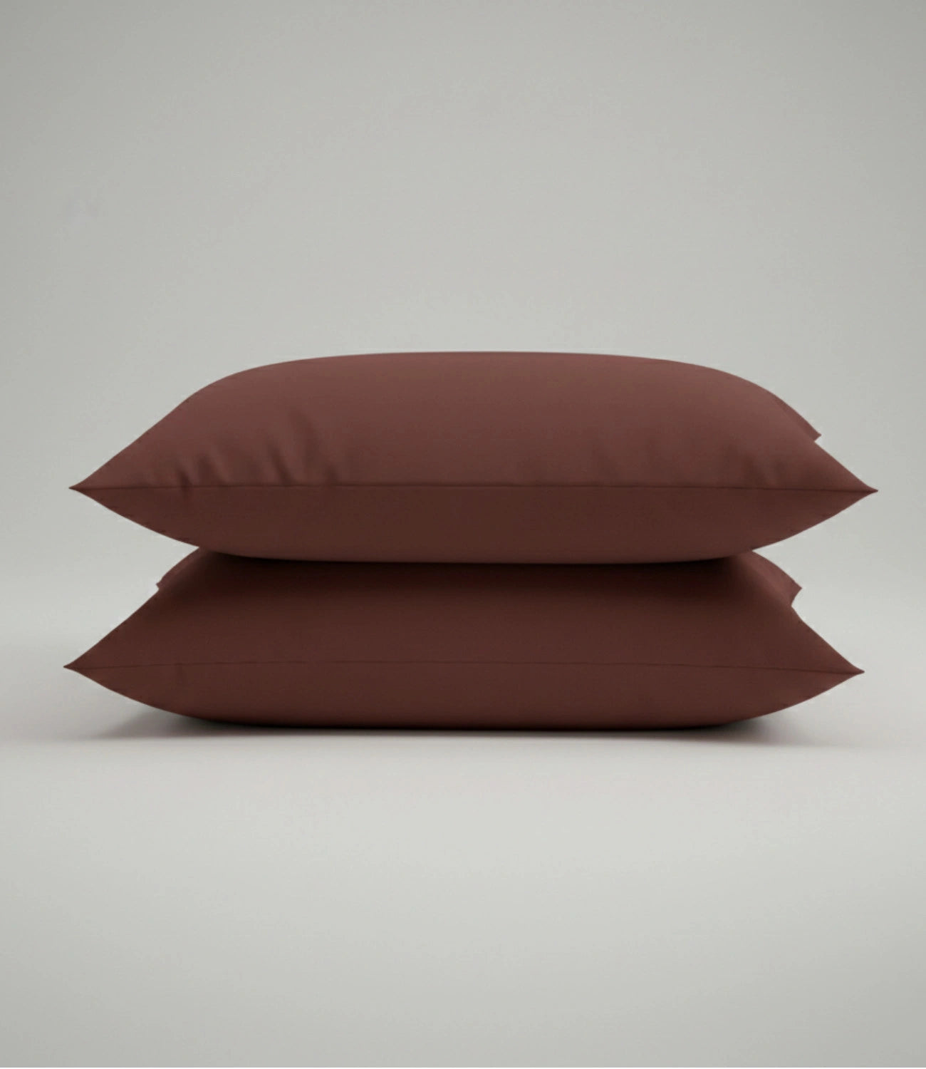 Set of two coffee brown cotton pillow covers for king size bedding, featuring a soft, breathable fabric with a clean, modern design.