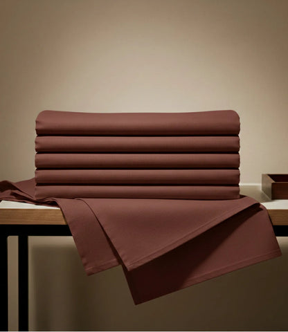 Folded coffee brown king size cotton bedsheet set with matching pillow covers, highlighting premium fabric, smooth texture, and elegant finish.