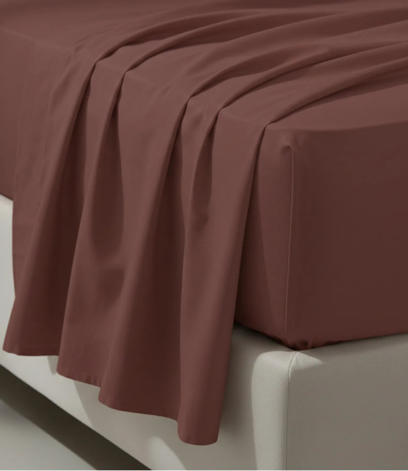 Close-up of a coffee brown king size cotton bedsheet displaying a soft drape, fine stitching, wrinkle-resistant texture, and premium craftsmanship.