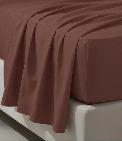 Close-up of a coffee brown king size cotton bedsheet displaying a soft drape, fine stitching, wrinkle-resistant texture, and premium craftsmanship.