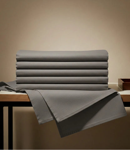 Folded Soft Heaven dark grey king size cotton bedsheet displaying premium fabric, solid color, and soft breathable texture.
