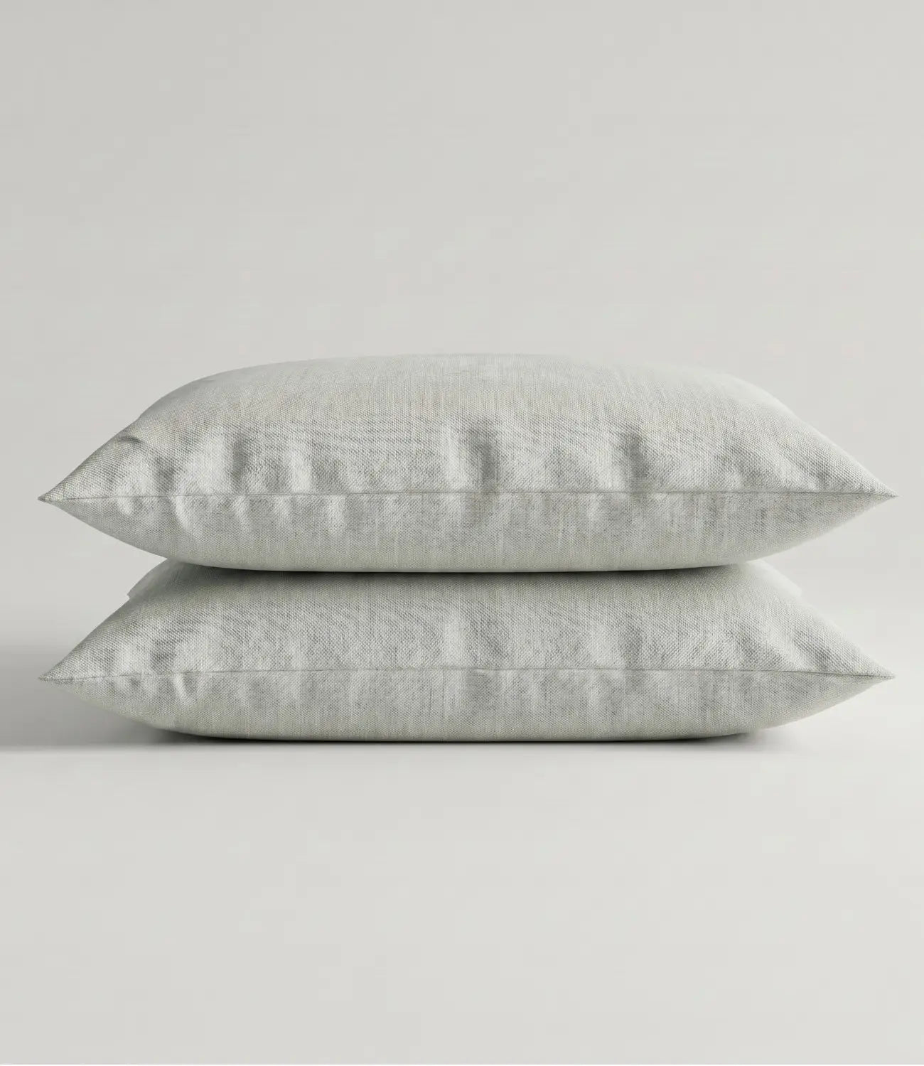 Pair of solid mint green cotton pillow covers stacked neatly, highlighting the soft fabric, clean stitching, and premium quality that complements king size bedding collections.