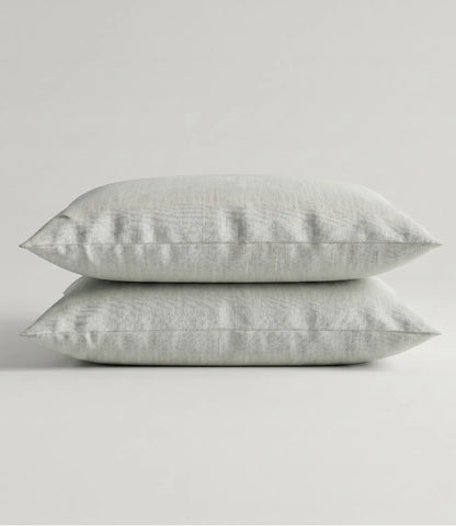 Pair of solid mint green cotton pillow covers stacked neatly, highlighting the soft fabric, clean stitching, and premium quality that complements king size bedding collections.