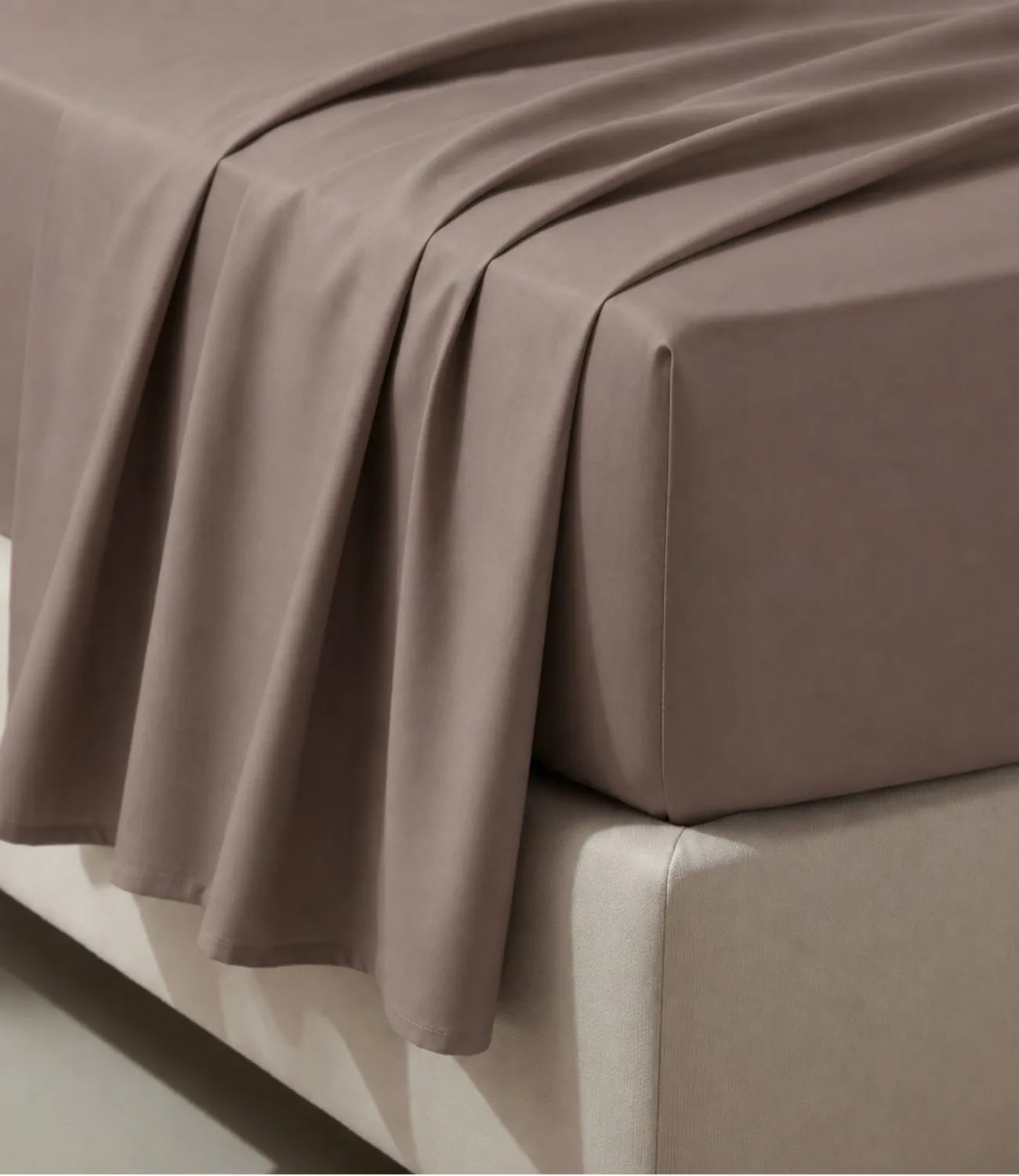 Close-up of taupe king size cotton bedsheet highlighting smooth texture, elegant drape, and premium stitching