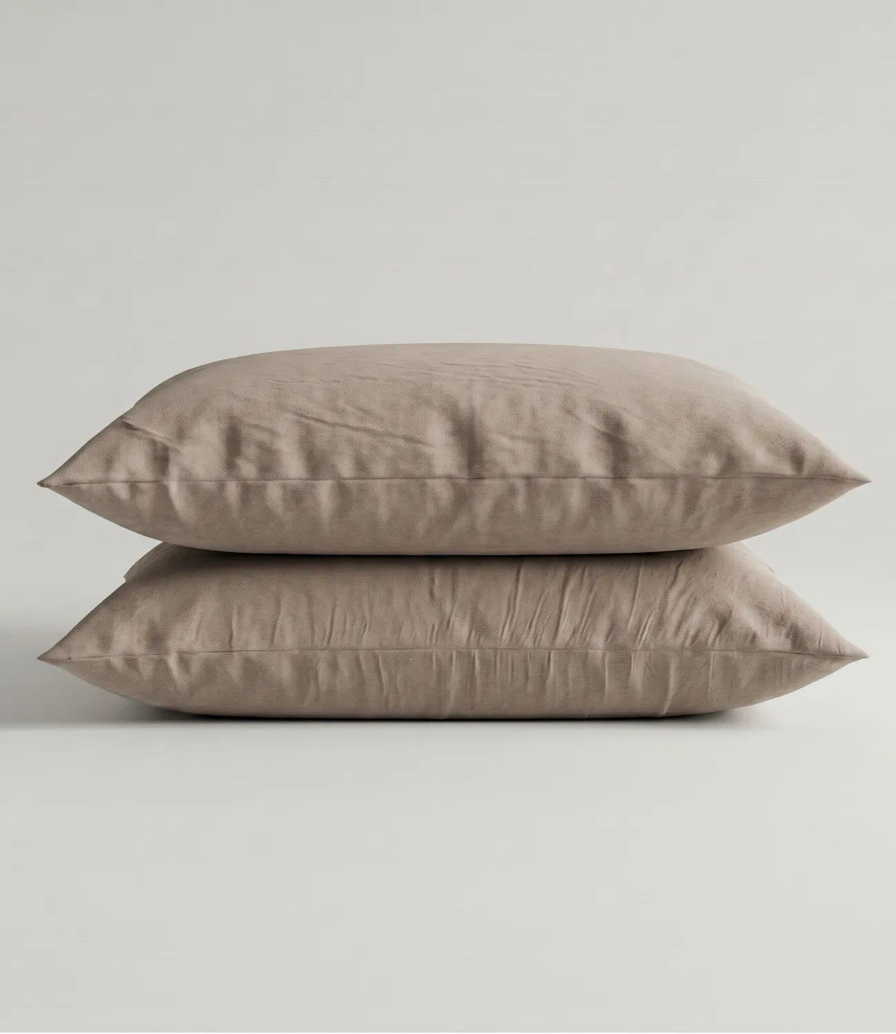 Matching 100% pure cotton mocha solid pillow covers featuring a soft breathable fabric, premium stitching, and elegant minimalist styling for a refined bedroom.