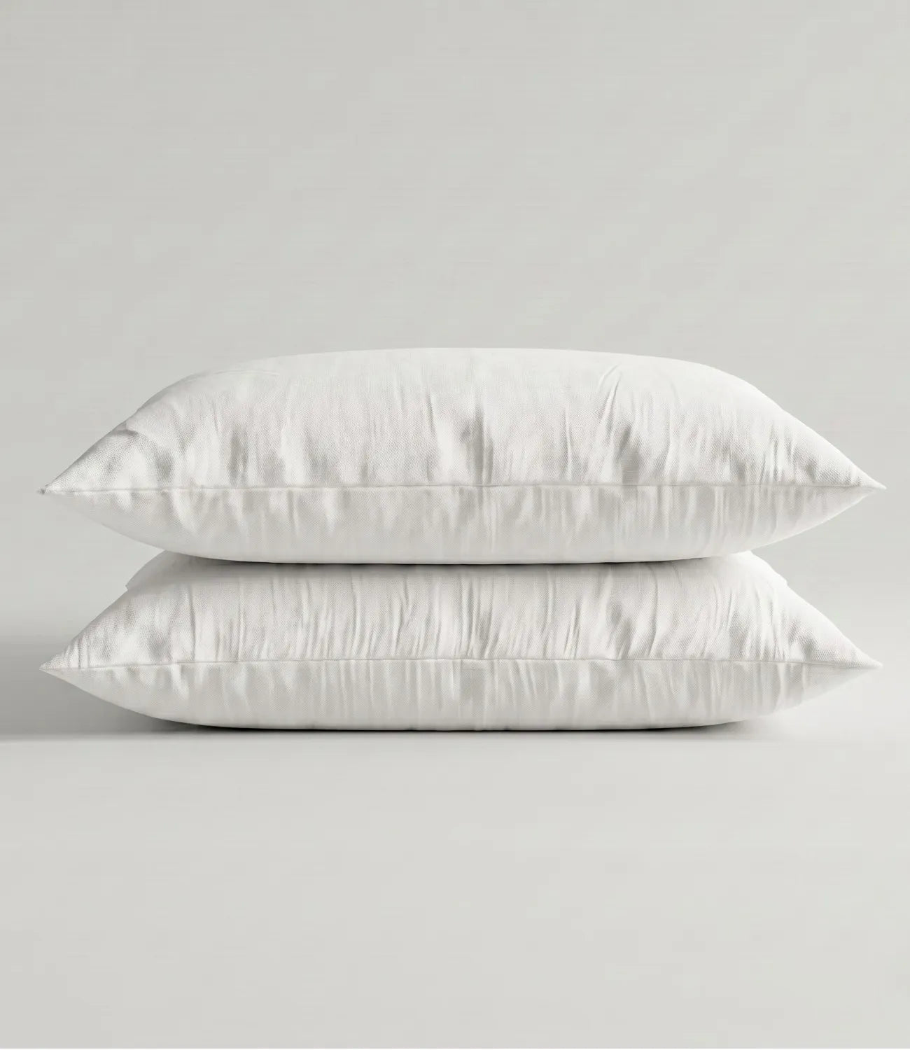 Matching 100% pure cotton white solid pillow covers featuring breathable fabric, premium stitching, soft texture, and elegant minimalist styling.