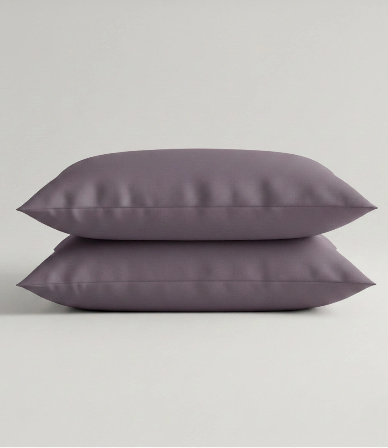 Set of two Soft Heaven plum cotton pillow covers in solid plum color with a smooth and soft fabric finish.