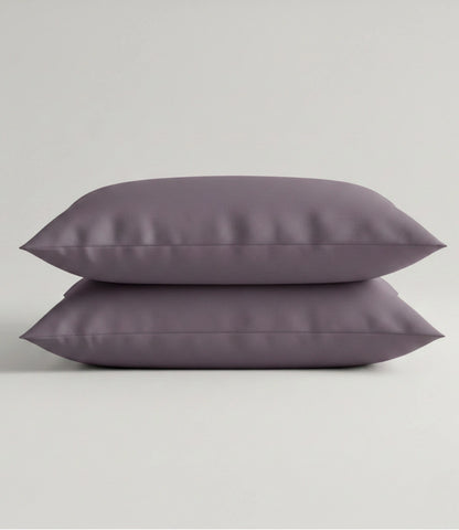Set of two Soft Heaven plum cotton pillow covers in solid plum color with a smooth and soft fabric finish.