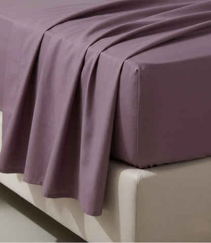 Close-up of Soft Heaven plum king size fitted cotton bedsheet highlighting smooth texture, neat stitching, and wrinkle-resistant finish.