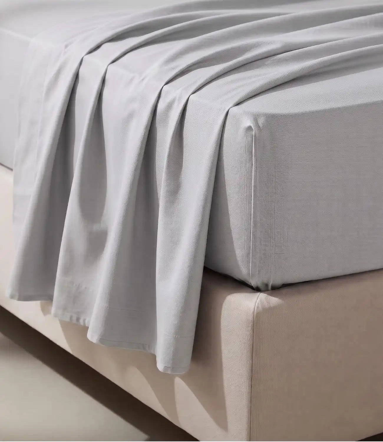 Close-up of Soft Heaven silver grey king size cotton bedsheet showing smooth fabric texture, elegant drape, and fitted mattress corner